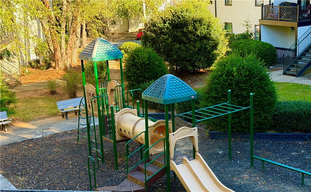 3595 Woodbriar Circle, Unit N Tucker, GA 30084 - Photo 35 of 39 a backyard of a house with table and chairs