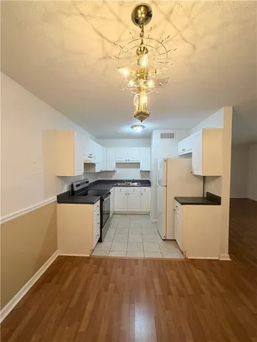 a kitchen with stainless steel appliances granite countertop a sink and a refrigerator