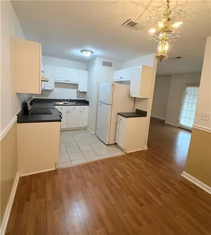 a kitchen with a stove a refrigerator and a sink
