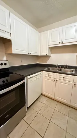a kitchen with cabinets and a stove top oven