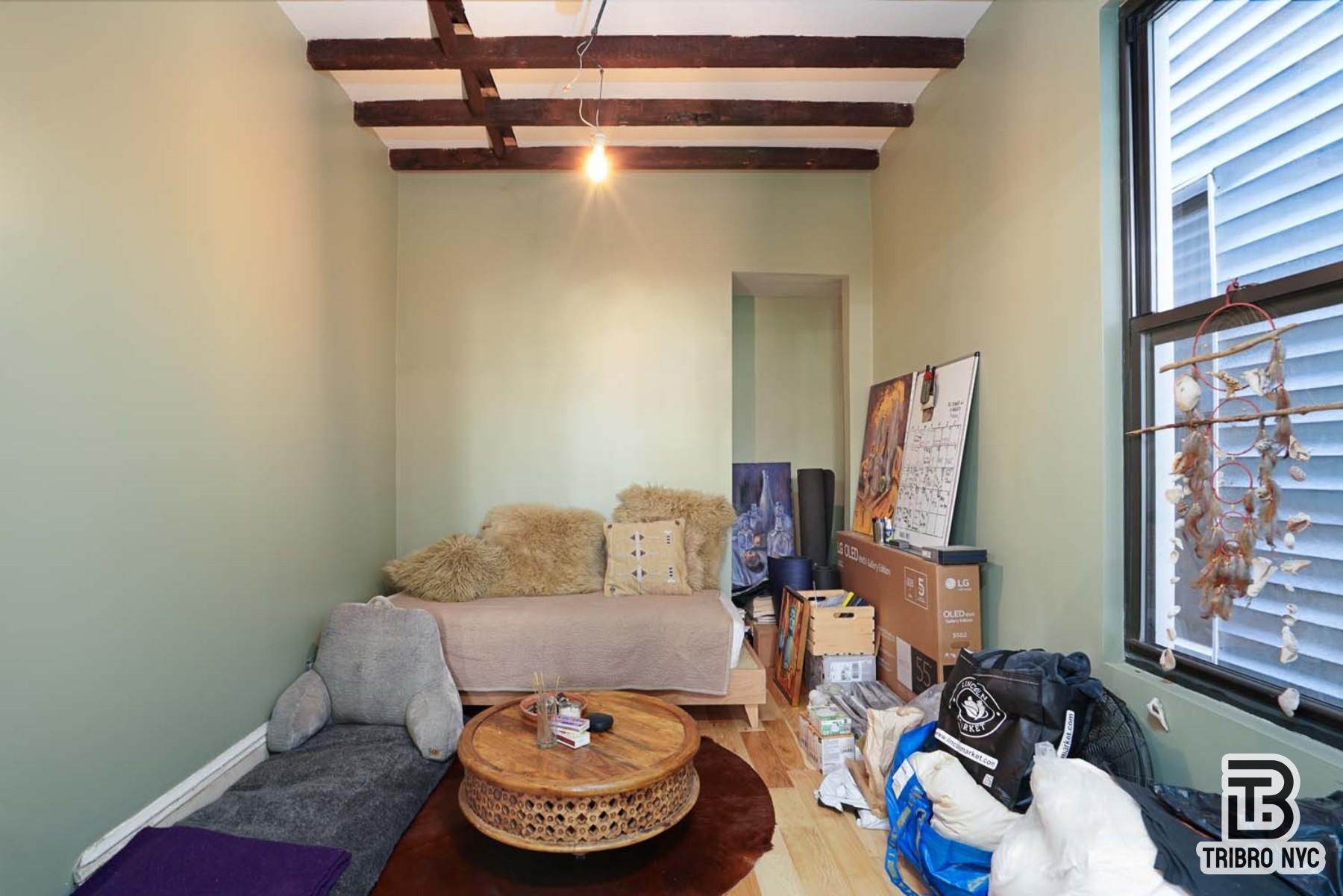 60-42 Grove Street, Unit 2R Queens, NY 11385 - Photo 5 of 7 a living room with furniture and a window