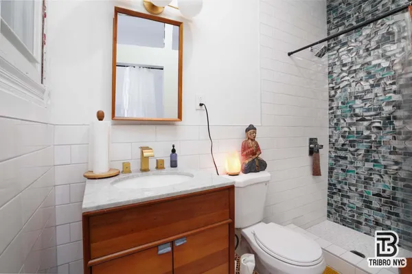 a bathroom with a sink a toilet and shower curtain