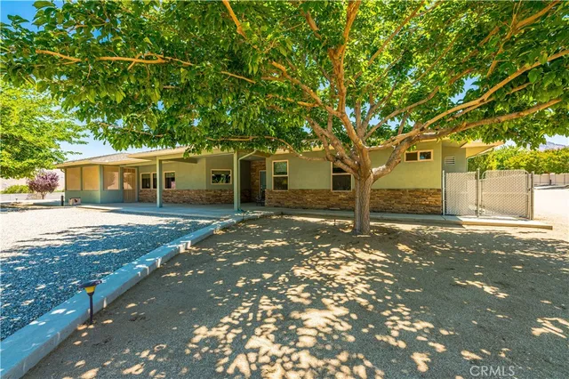 a kitchen with stainless steel appliances kitchen island granite countertop a table and chairs