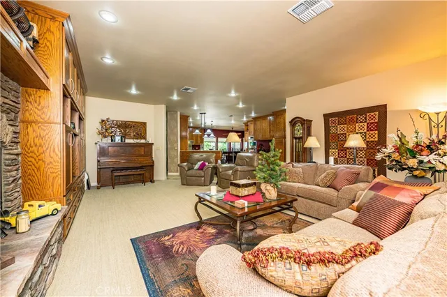 a dining room with furniture and a floor to ceiling window