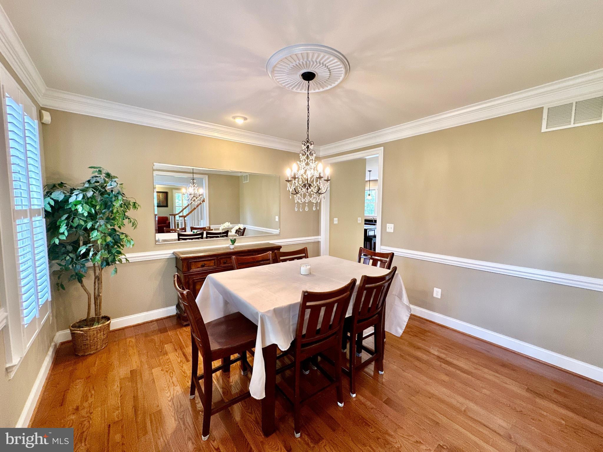 513 Broad Stream Lane Riva, MD 21140 - Photo 13 of 67 a dining room with furniture potted plants and wooden floor