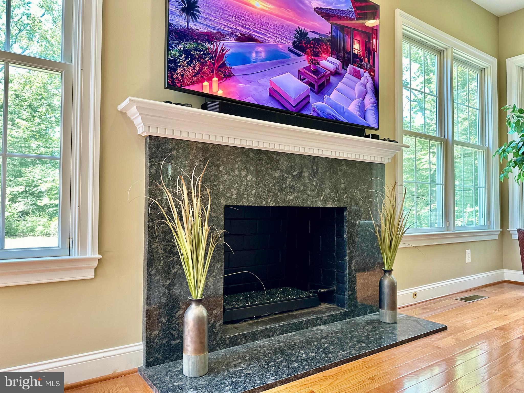 513 Broad Stream Lane Riva, MD 21140 - Photo 24 of 67 a living room with a fireplace windows and a wooden floor