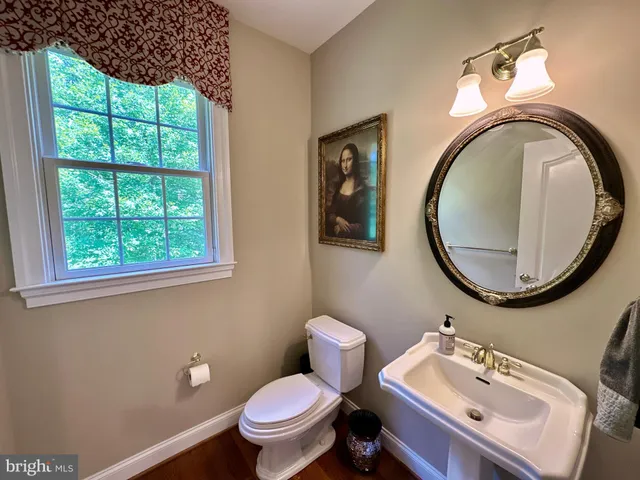 a spacious bathroom with a granite countertop sink mirror and shower