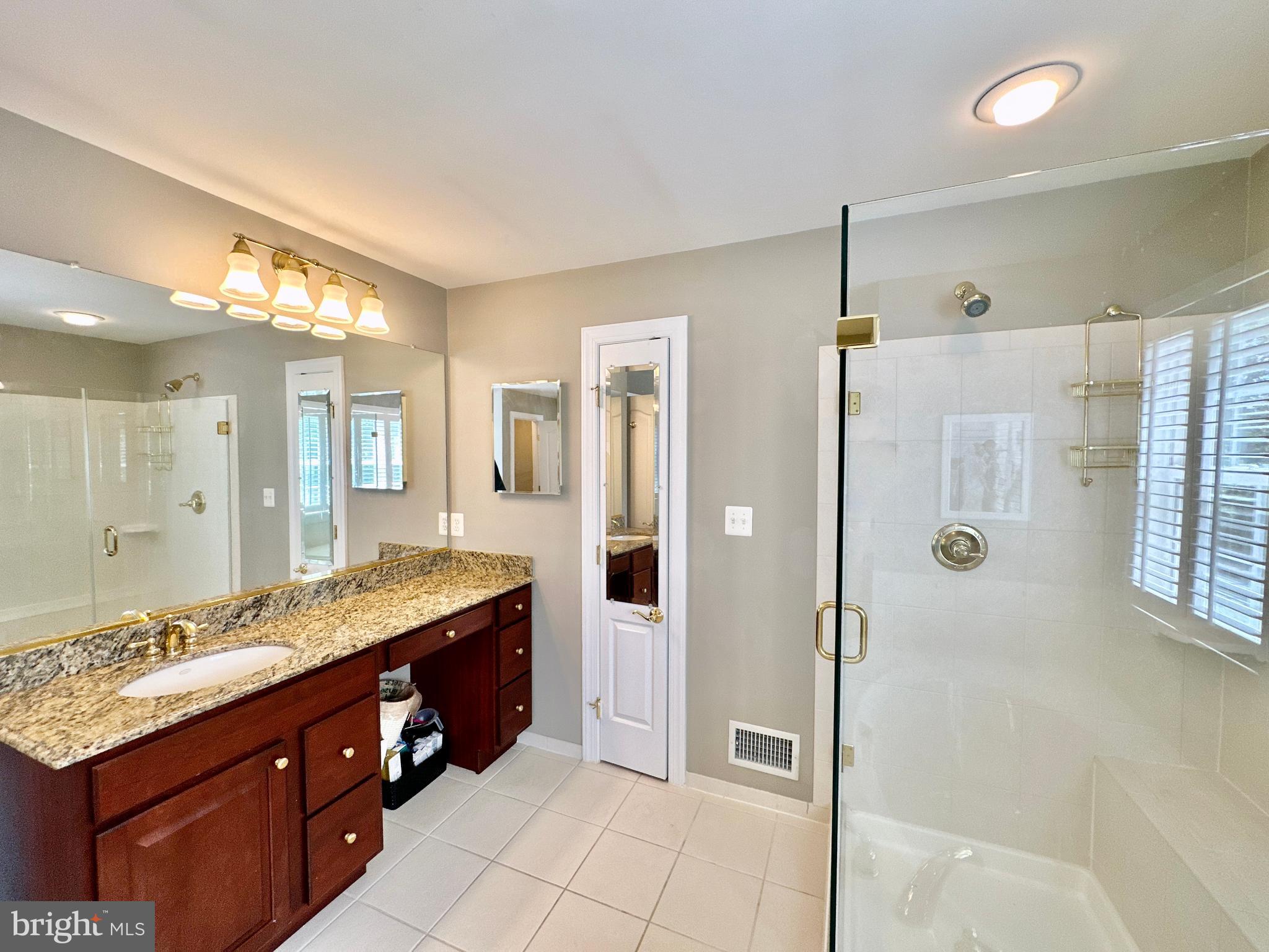 513 Broad Stream Lane Riva, MD 21140 - Photo 41 of 67 a spacious bathroom with a granite countertop sink mirror and shower