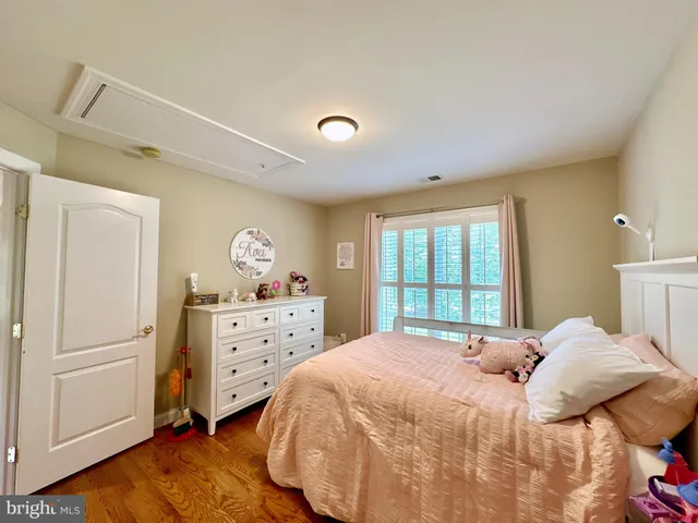 a bedroom with two bed and a flat screen tv