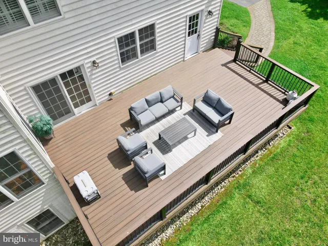an aerial view of a house with swimming pool and garden
