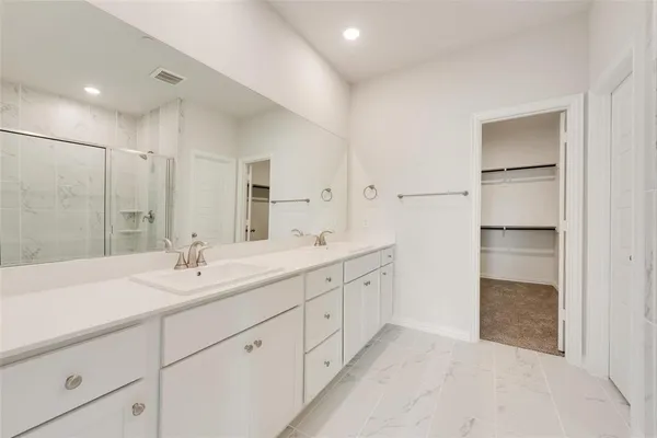 a bathroom with a double vanity sink and mirror
