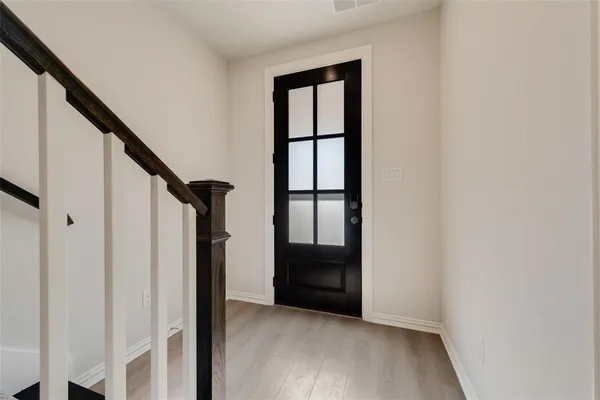 a view of entryway with stairs and wooden floor