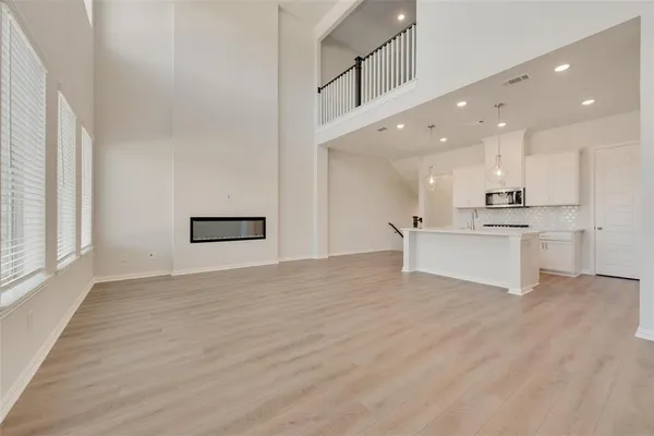 a view of kitchen with wooden floor and electronic appliances