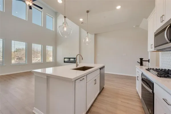 a kitchen with a sink stove and cabinets