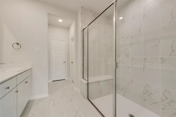 a bathroom with a shower and a sink