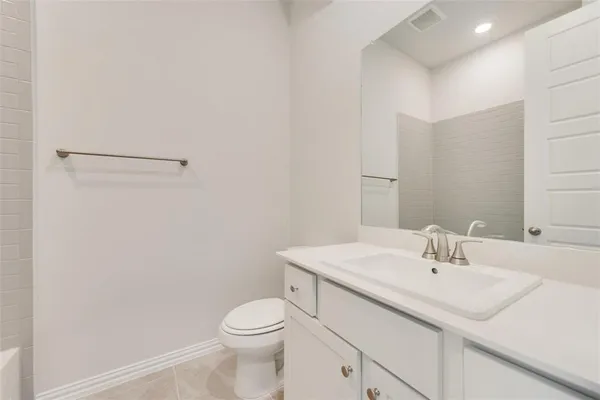 a bathroom with a sink toilet and vanity