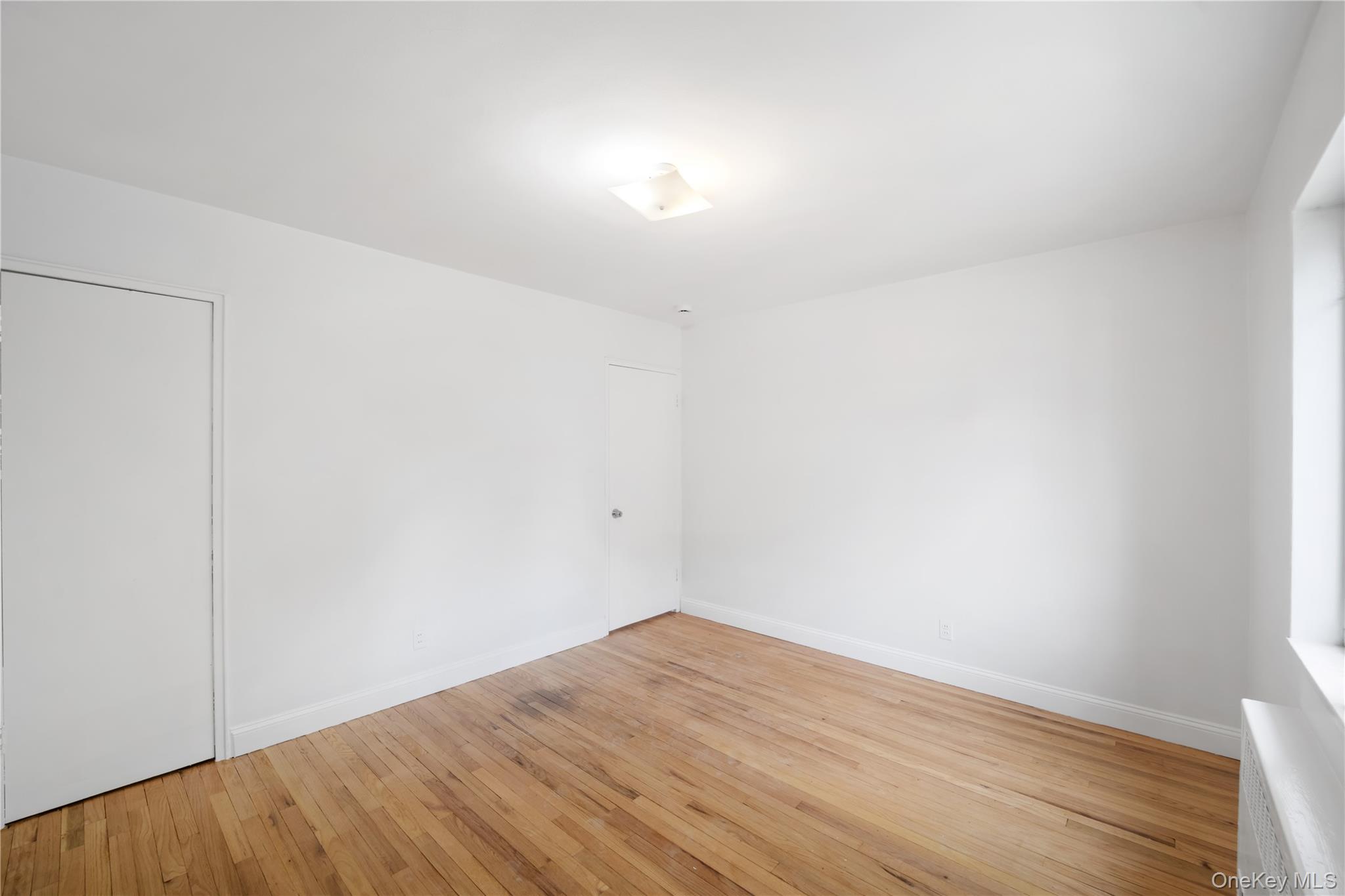 221-26 Manor Road, Unit 116 Queens, NY 11427 - Photo 13 of 19 a view of empty room with wooden floor