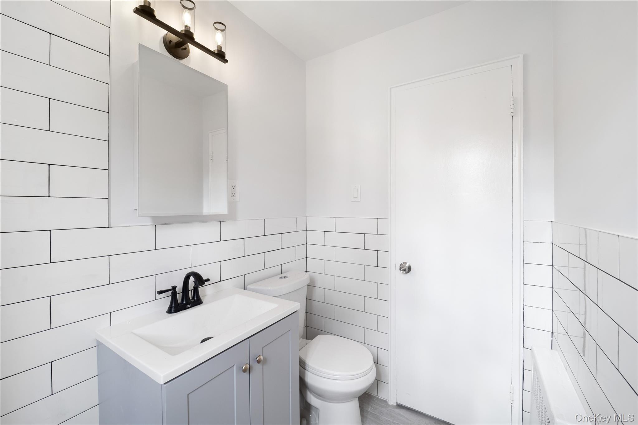 221-26 Manor Road, Unit 116 Queens, NY 11427 - Photo 19 of 19 a bathroom with a sink toilet and vanity
