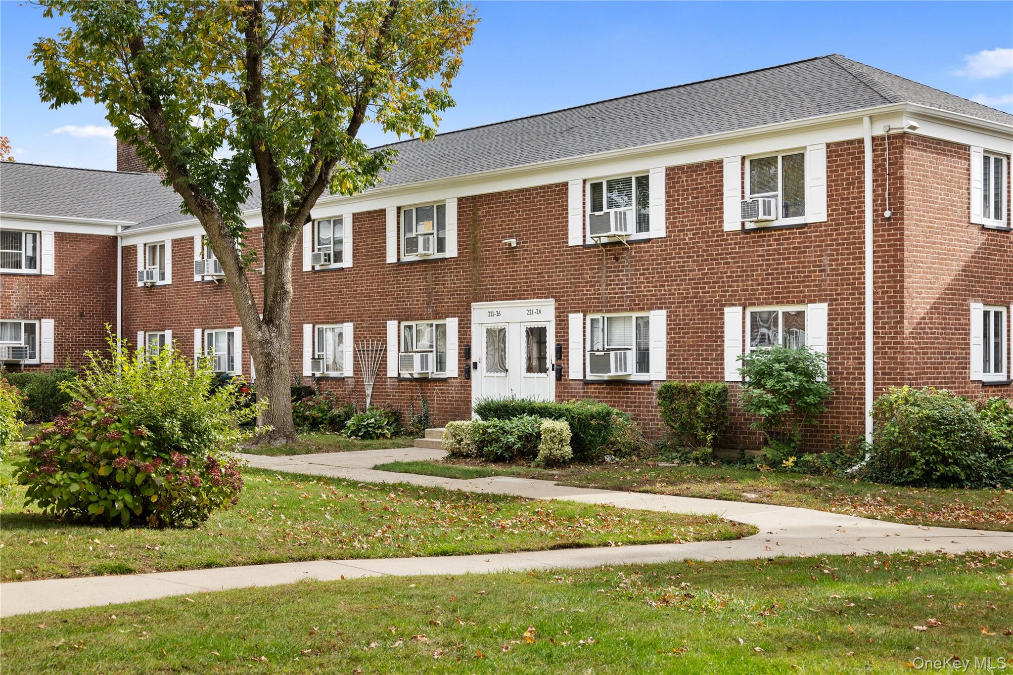 221-26 Manor Road, Unit 116 Queens, NY 11427 - Photo 3 of 19 a front view of a house with a yard