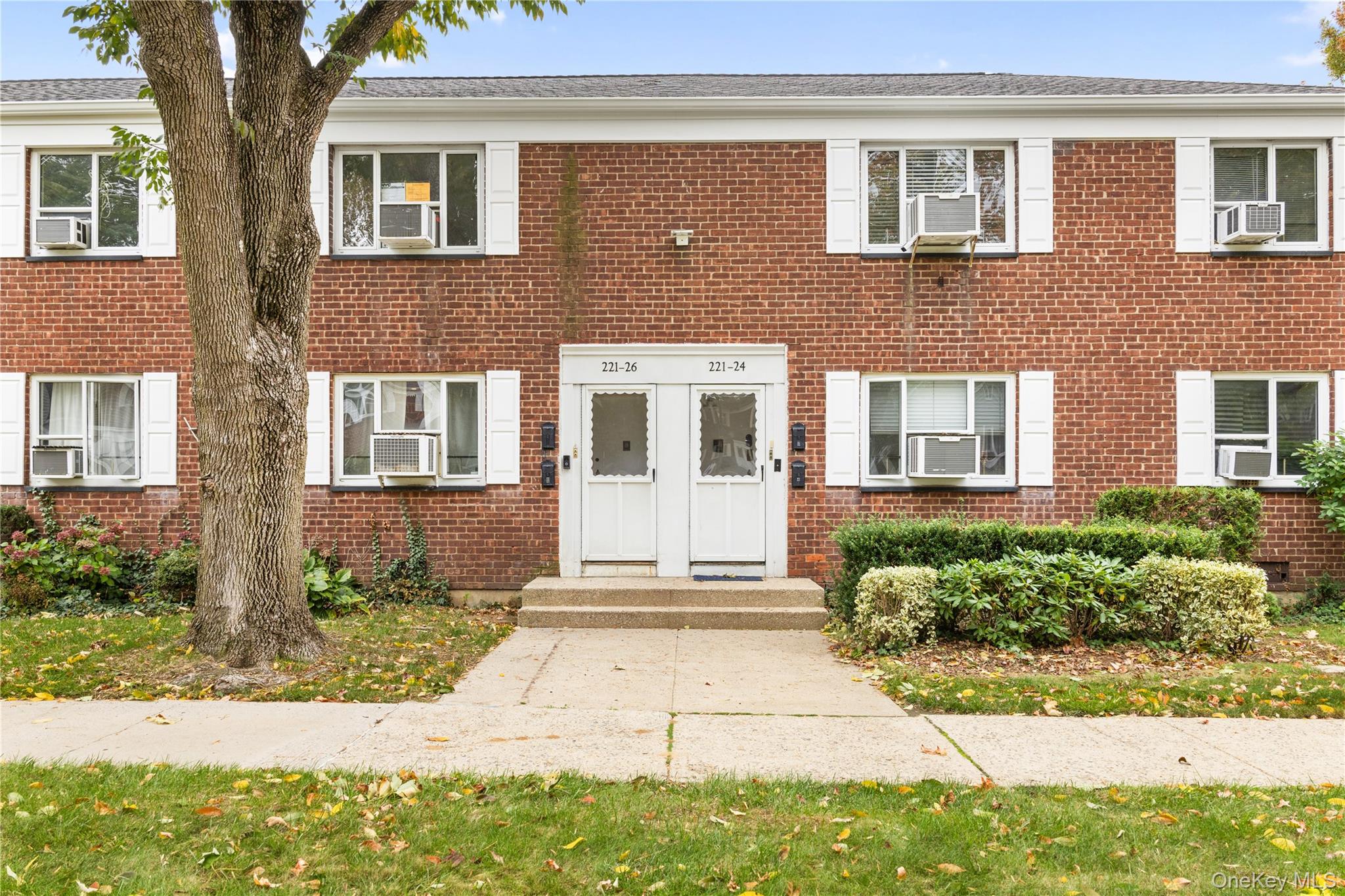221-26 Manor Road, Unit 116 Queens, NY 11427 - Photo 4 of 19 a front view of a house with a yard
