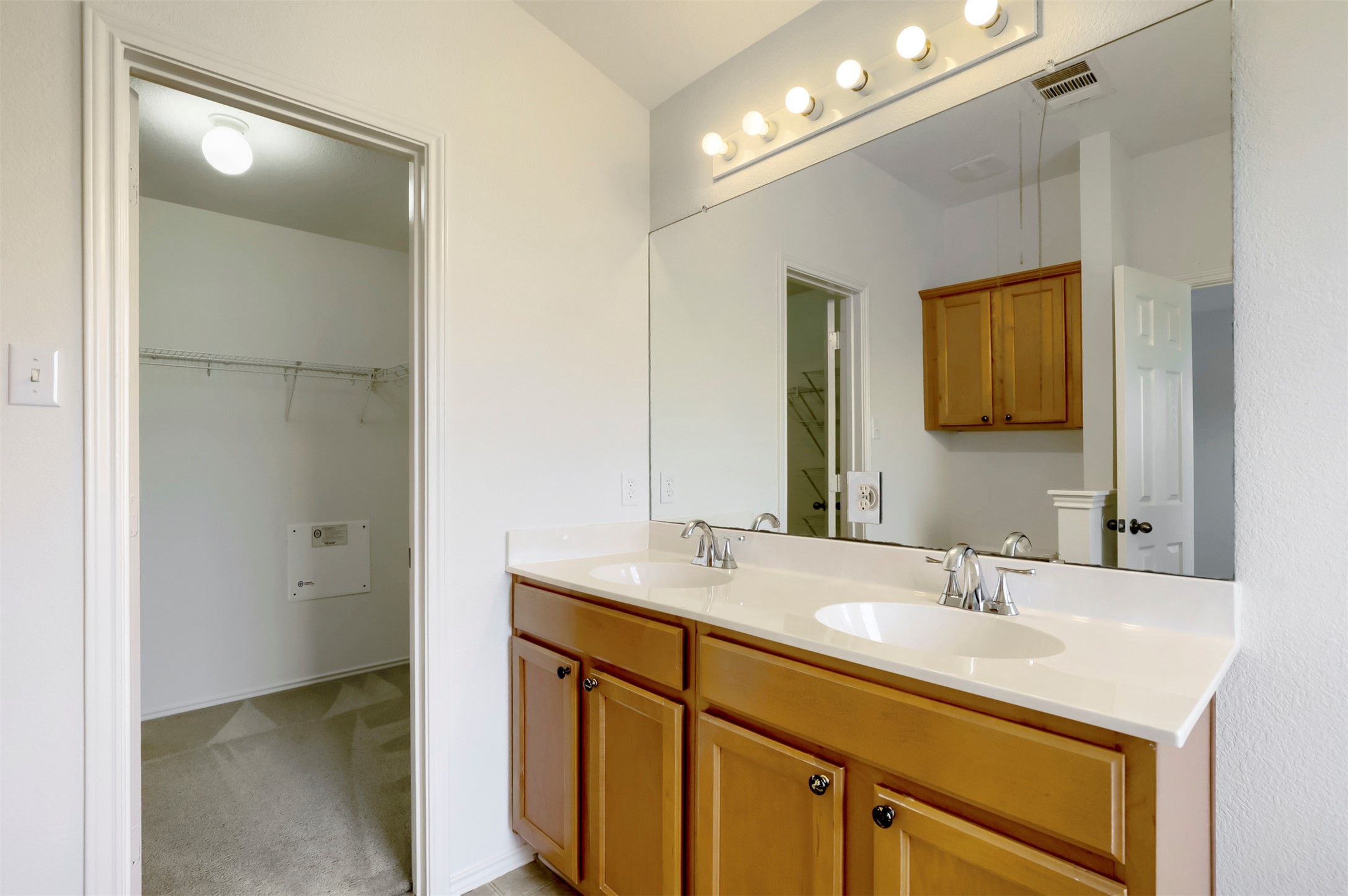 4125 Pebble Ridge Cove Round Rock, TX 78681 - Photo 20 of 30 A twin-sink vanity with abundant storage complements this well-lit primary bathroom space.