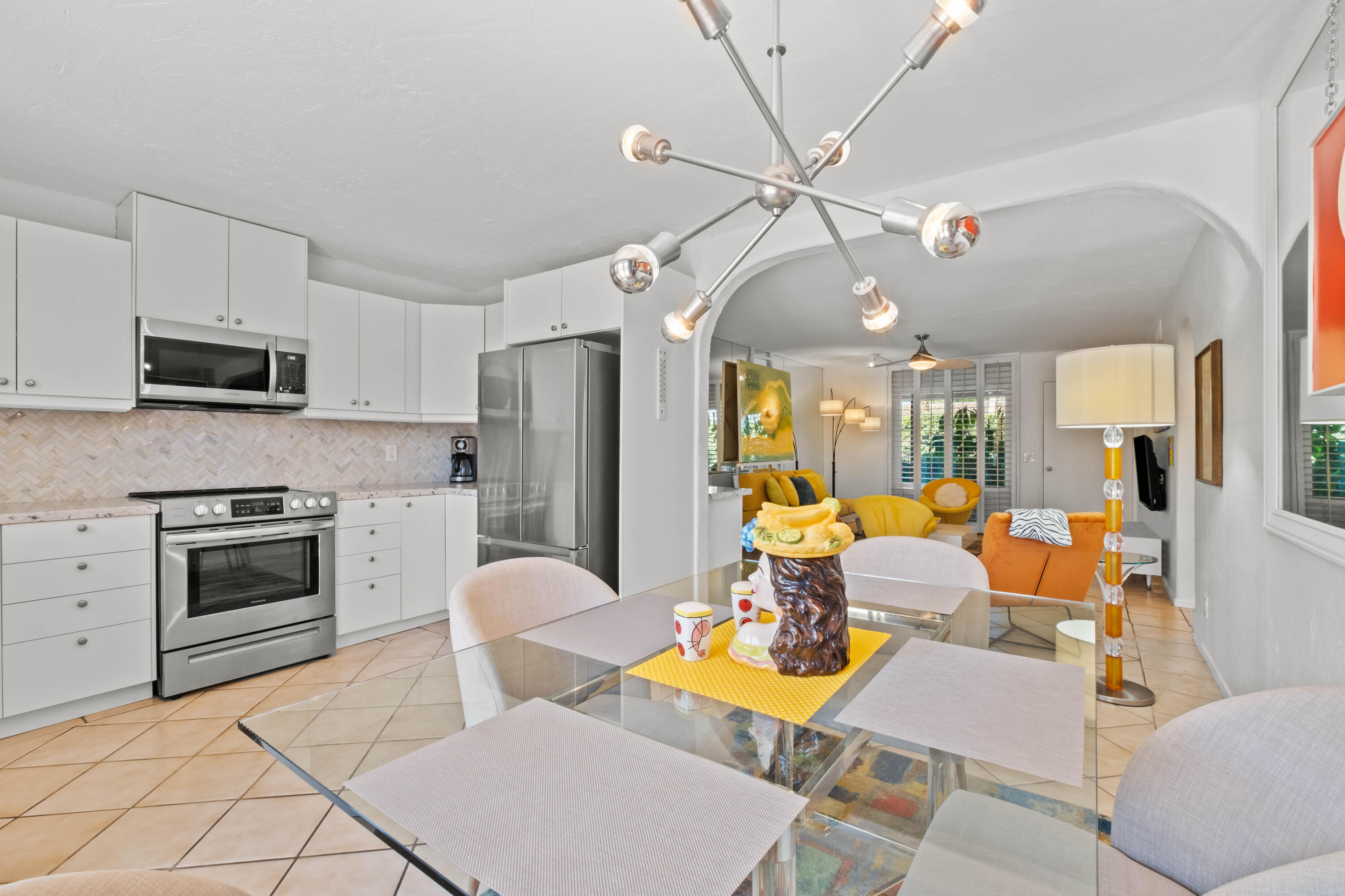 1268 Ramon Road, Unit 61 Palm Springs, CA 92264 - Photo 7 of 18 a living room with furniture a flat screen tv and kitchen view
