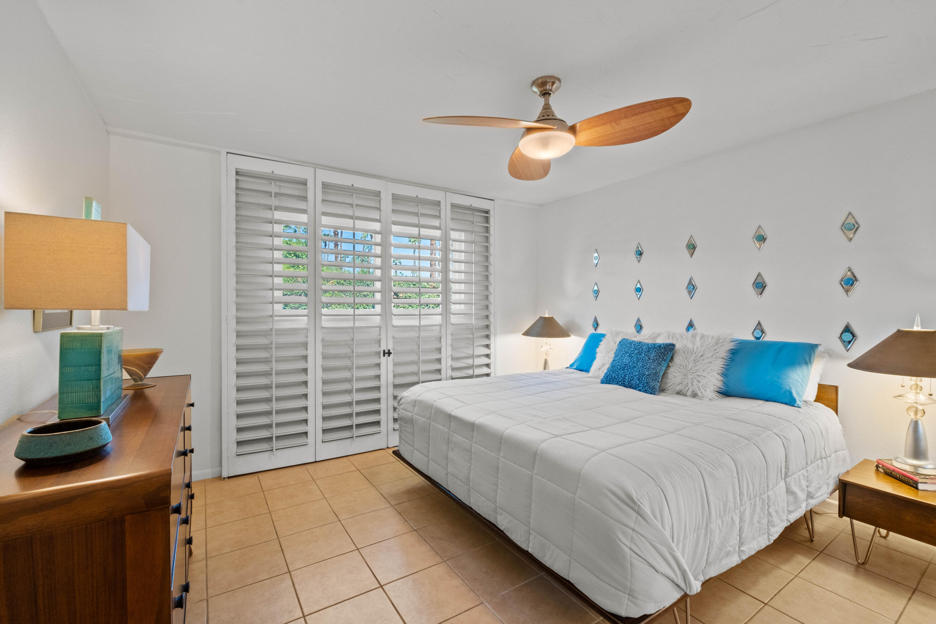 1268 Ramon Road, Unit 61 Palm Springs, CA 92264 - Photo 8 of 18 a bedroom with a bed and a flat tv screen on dresser