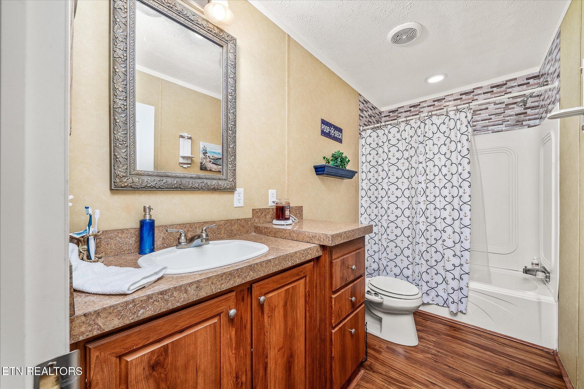 2025 Shiloh Road Decatur, TN 37322 - Photo 23 of 48 a bathroom with a granite countertop toilet sink and mirror