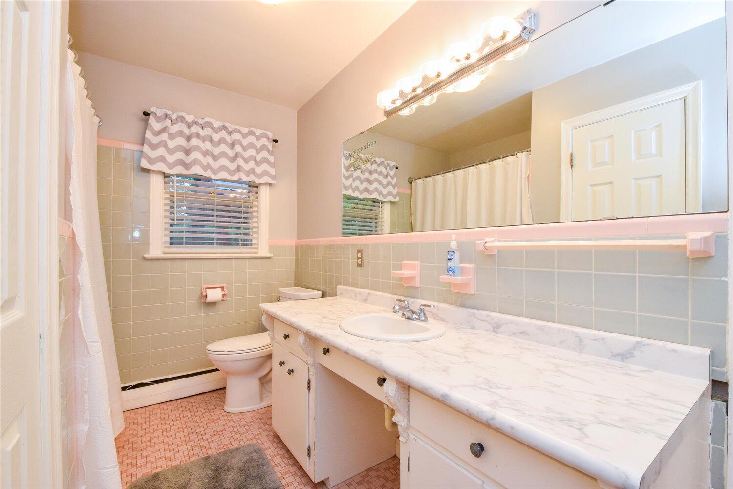 3060 Sedgefield Road Southwest Roanoke, VA 24018 - Photo 18 of 39 a bathroom with a granite countertop sink a large mirror and a toilet