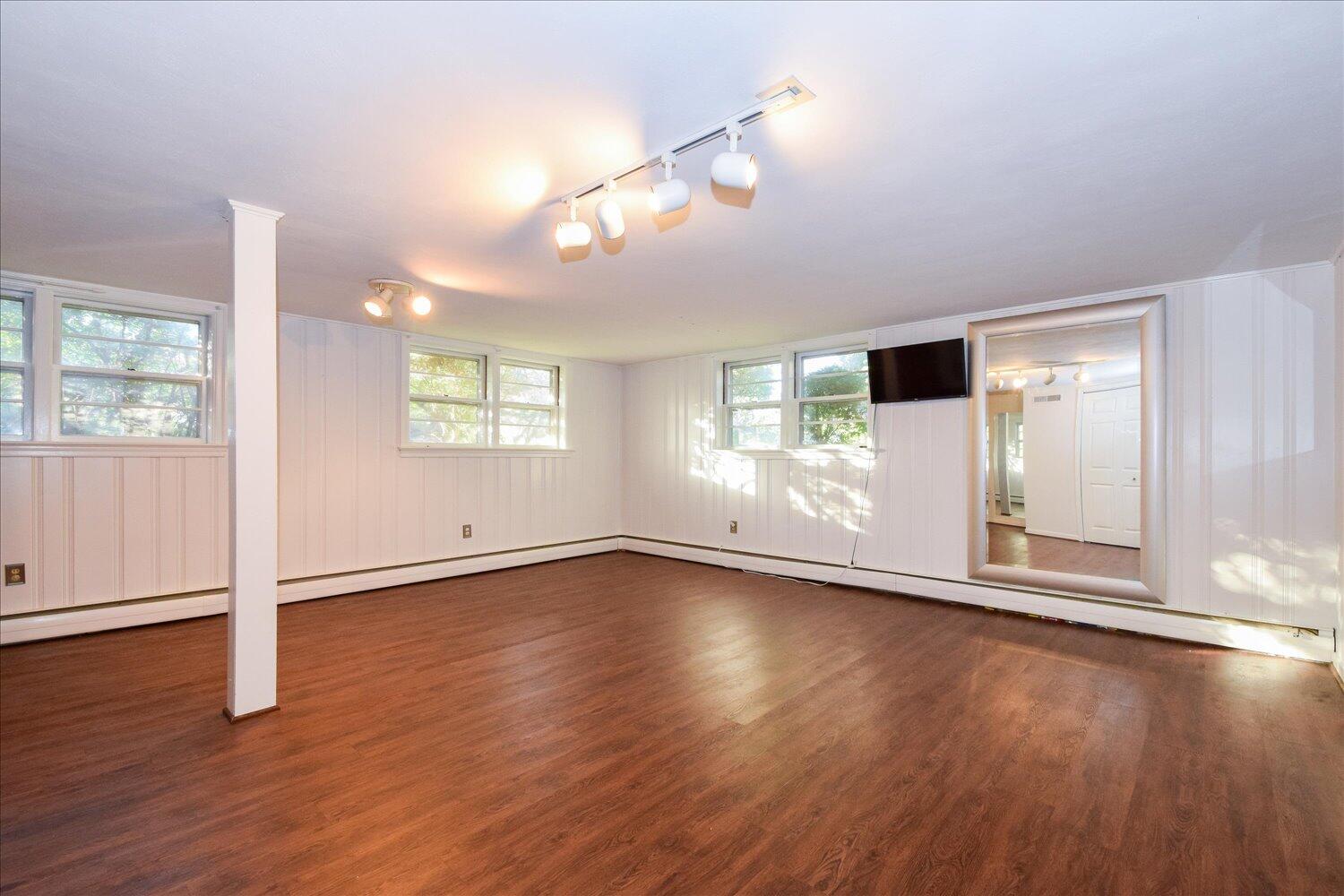 3060 Sedgefield Road Southwest Roanoke, VA 24018 - Photo 25 of 39 a view of an empty room with wooden floor and a window
