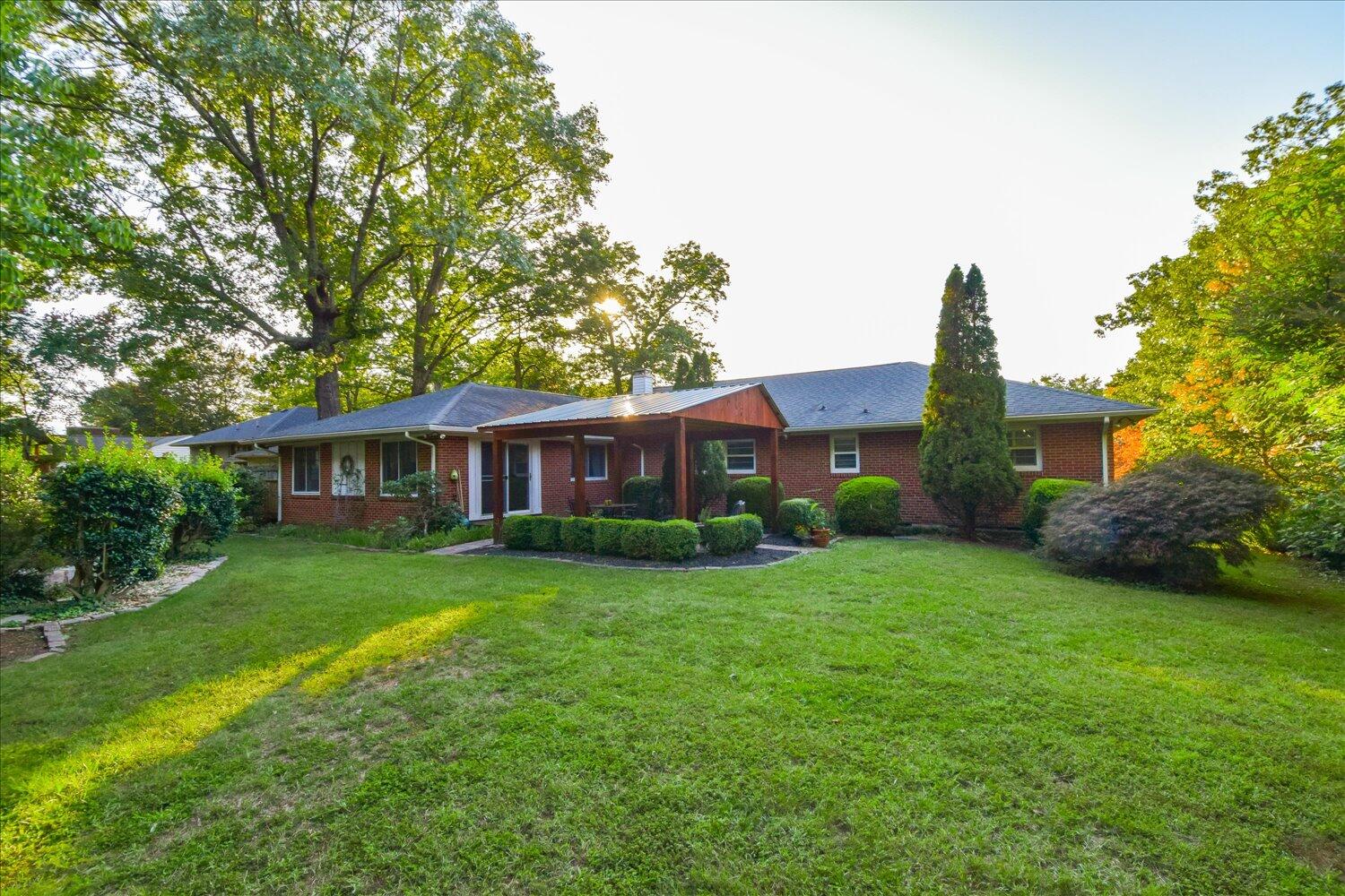 3060 Sedgefield Road Southwest Roanoke, VA 24018 - Photo 32 of 39 a view of a big yard in front of a house with a large tree