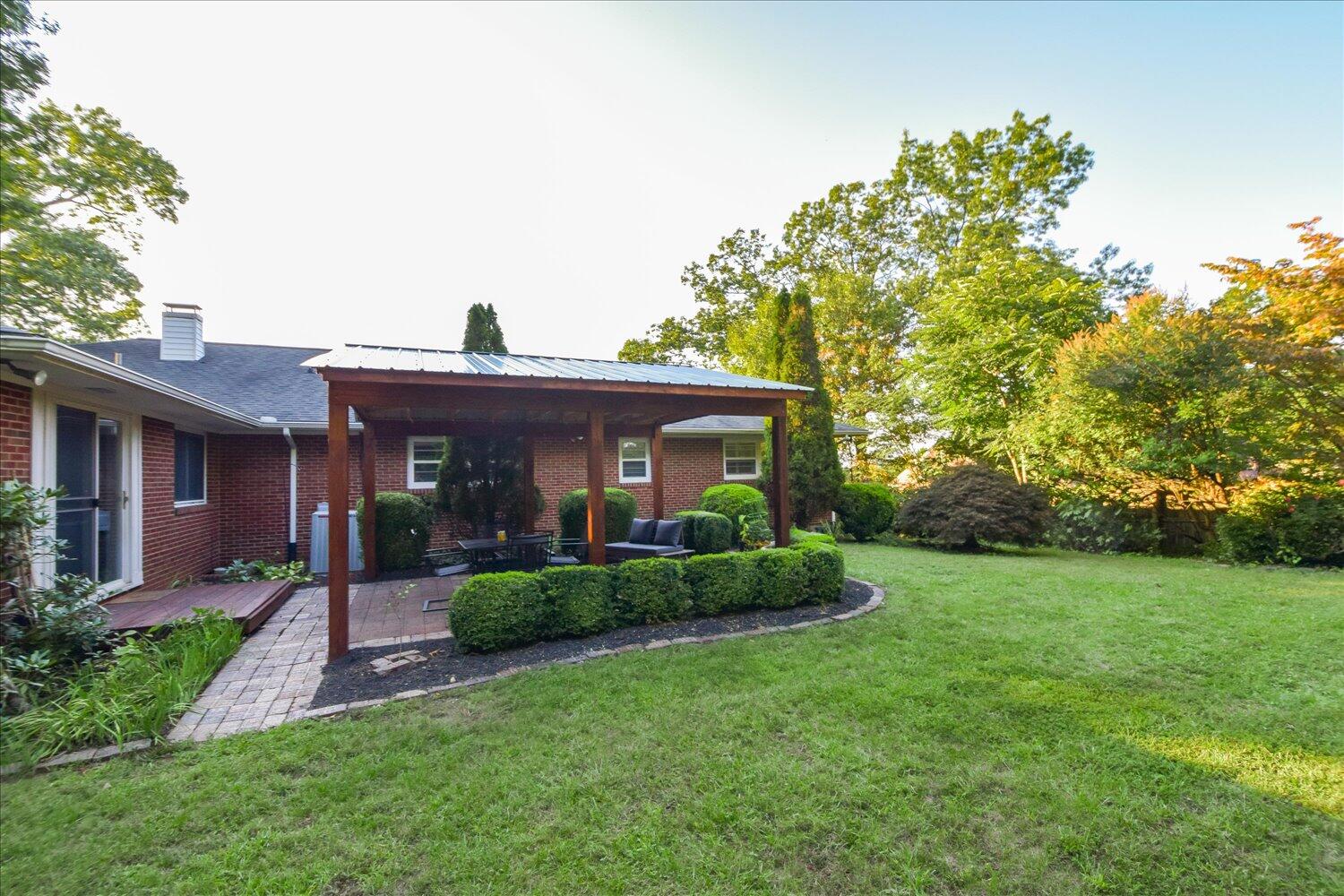 3060 Sedgefield Road Southwest Roanoke, VA 24018 - Photo 33 of 39 a front view of a house with a yard and potted plants