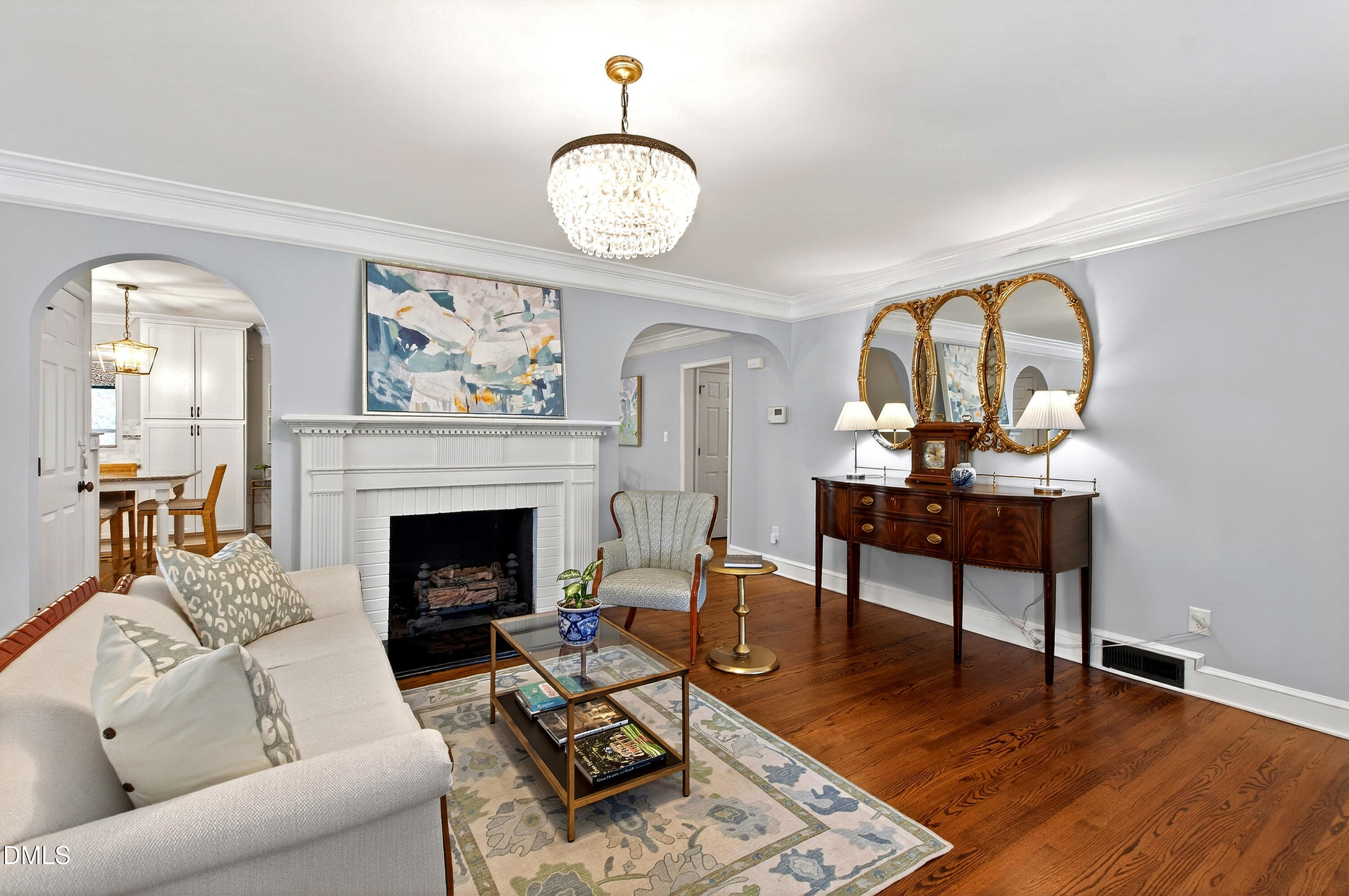 1205 Canterbury Road Raleigh, NC 27608 - Photo 7 of 48 a living room with furniture a fireplace and wooden floor