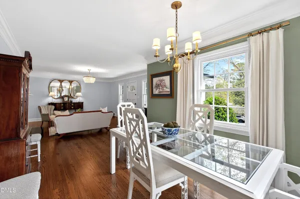 a living room with furniture a chandelier and a window