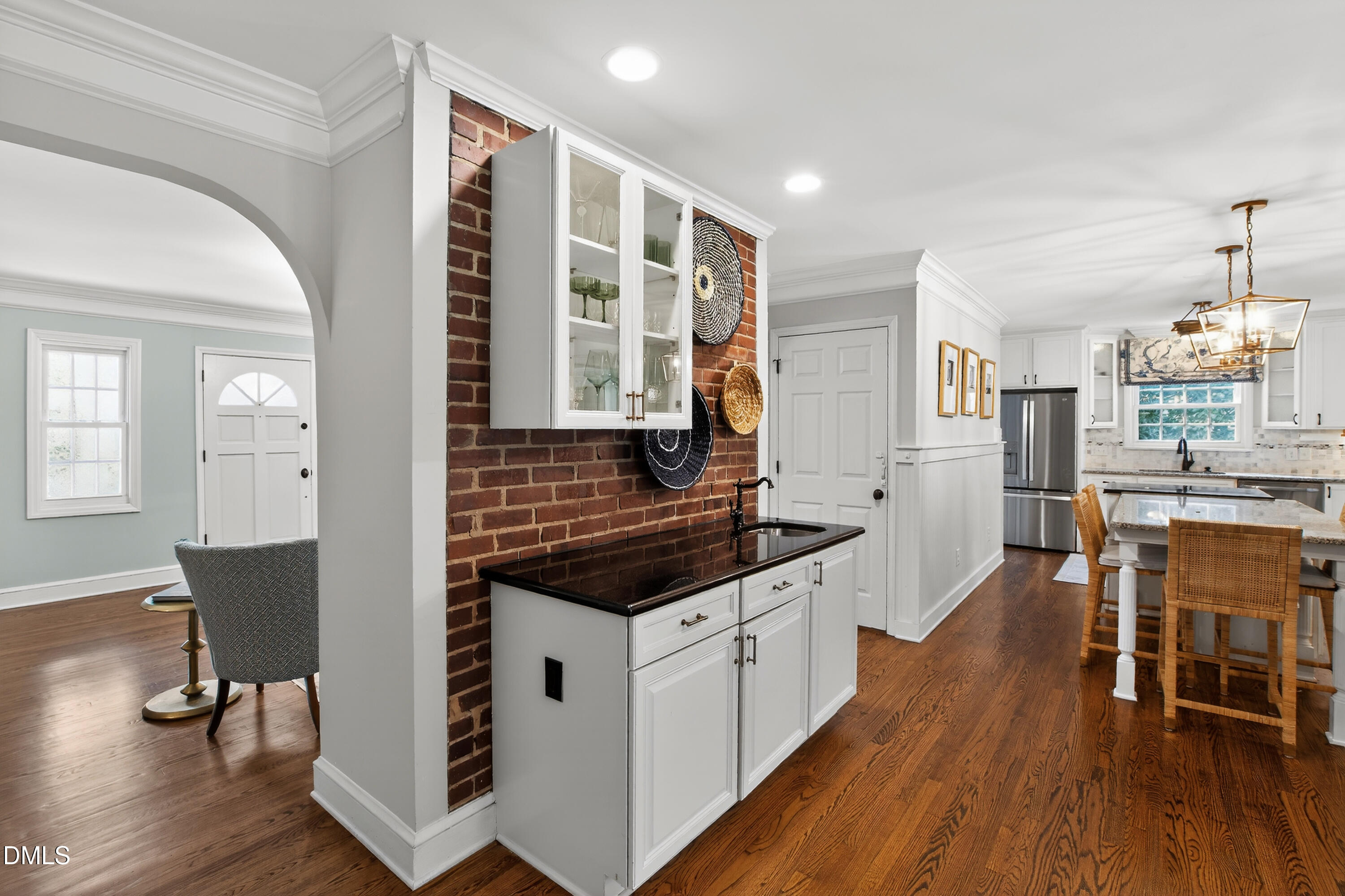 1205 Canterbury Road Raleigh, NC 27608 - Photo 11 of 48 a kitchen with stainless steel appliances granite countertop a stove a sink dishwasher and a dining table with wooden floor