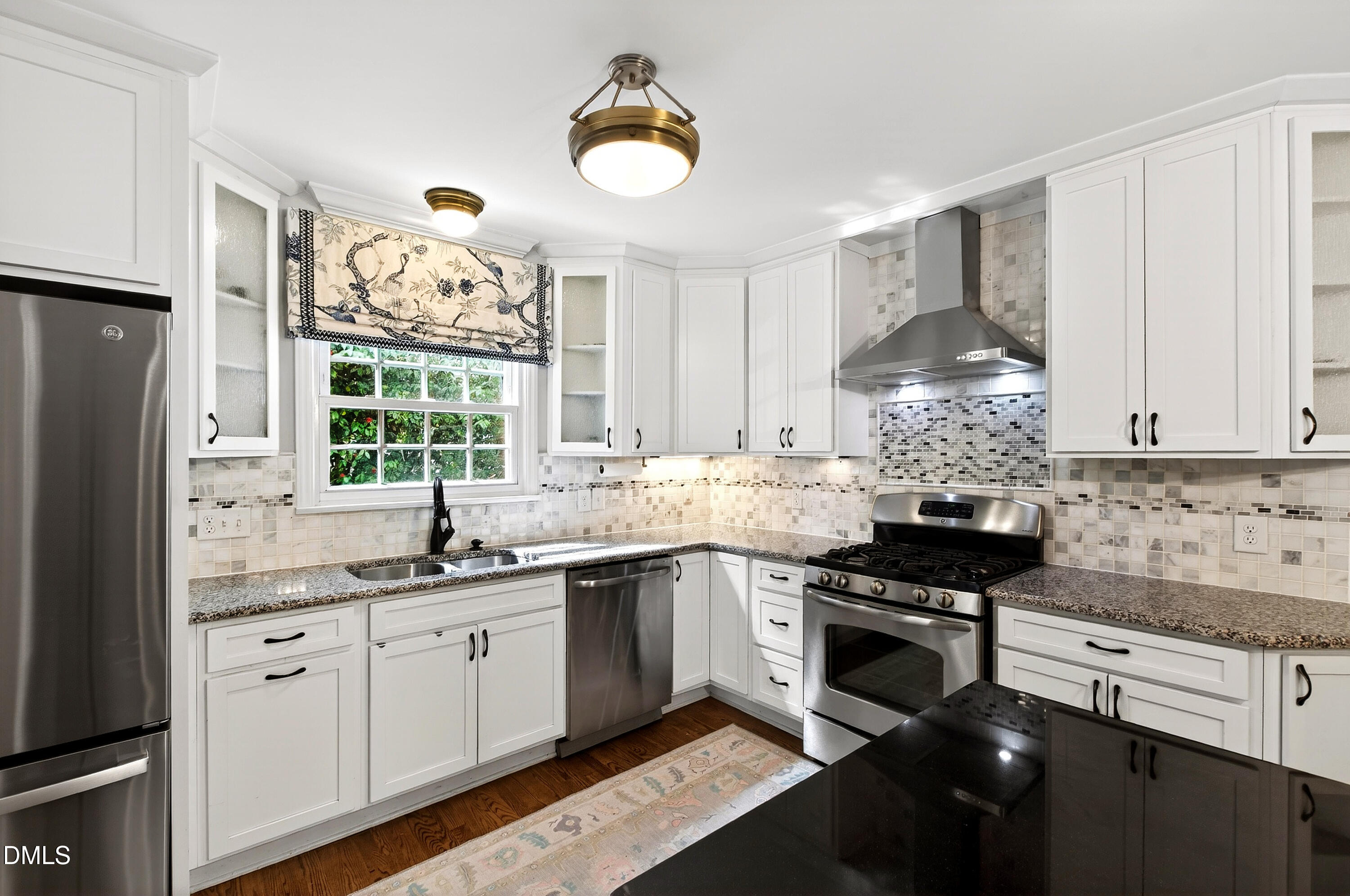 1205 Canterbury Road Raleigh, NC 27608 - Photo 14 of 48 a kitchen with granite countertop stainless steel appliances a sink stove and refrigerator