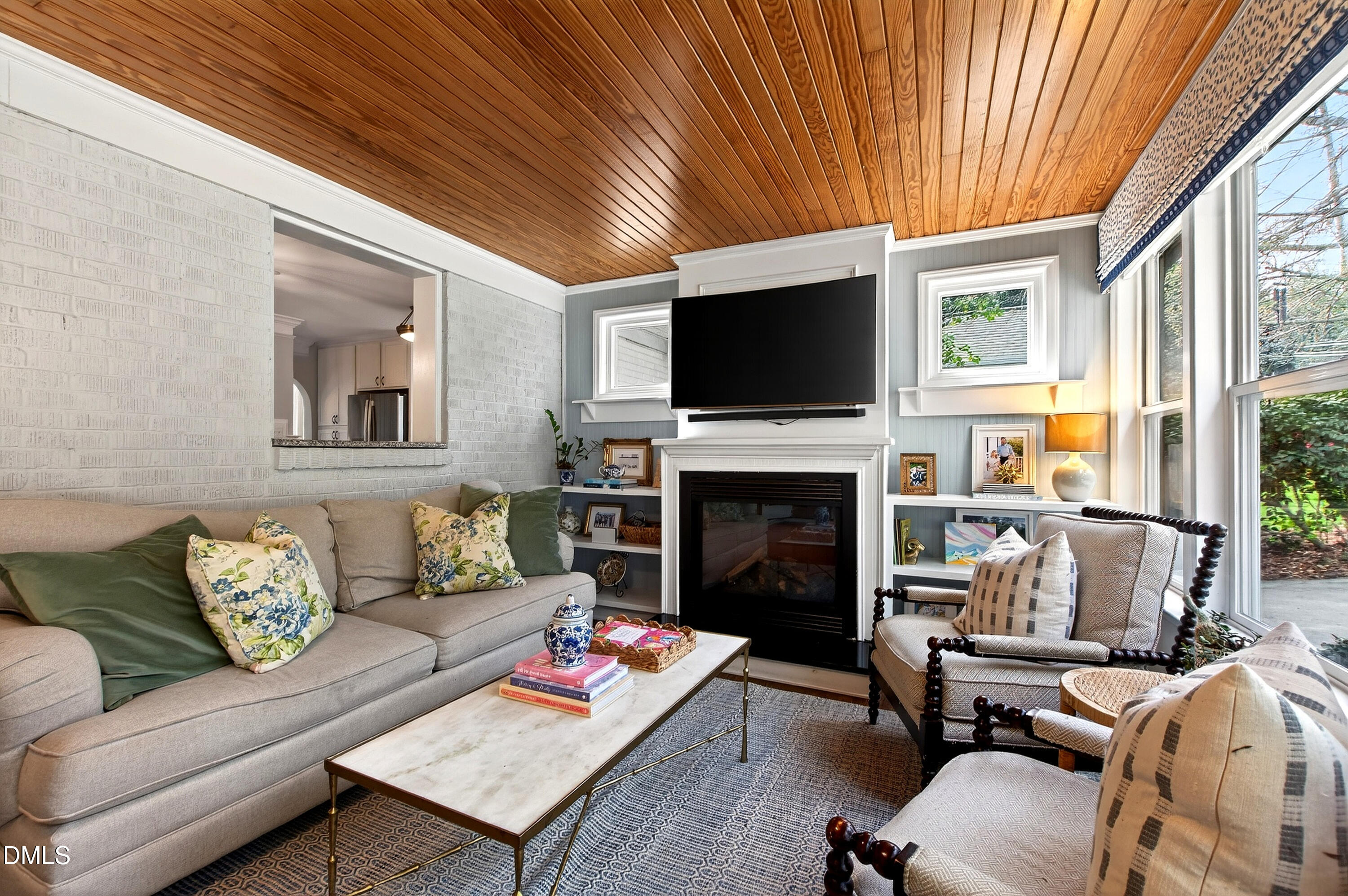 1205 Canterbury Road Raleigh, NC 27608 - Photo 20 of 48 a living room with furniture a fireplace and a flat screen tv