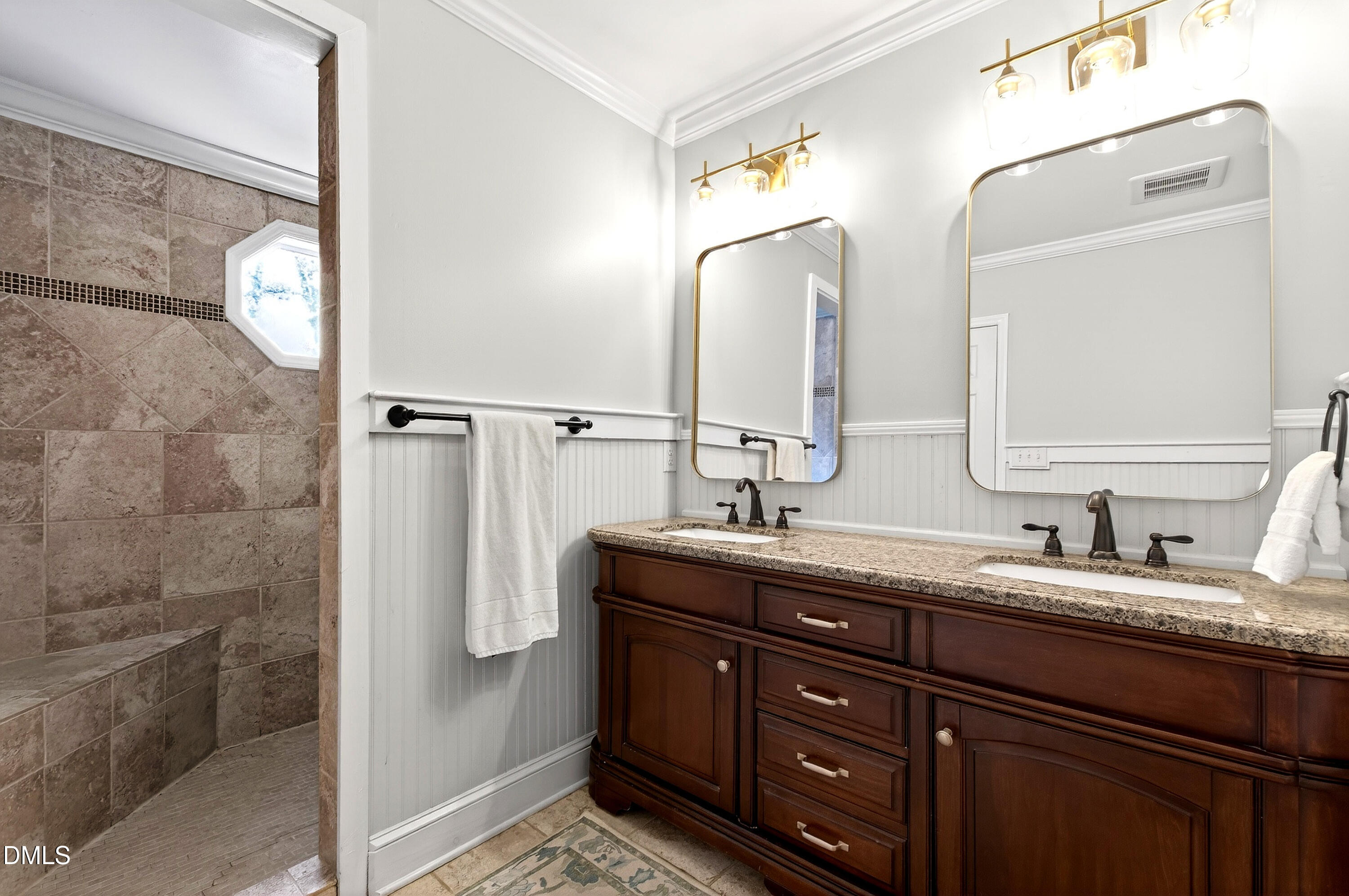 1205 Canterbury Road Raleigh, NC 27608 - Photo 24 of 48 a bathroom with a double vanity sink and mirror