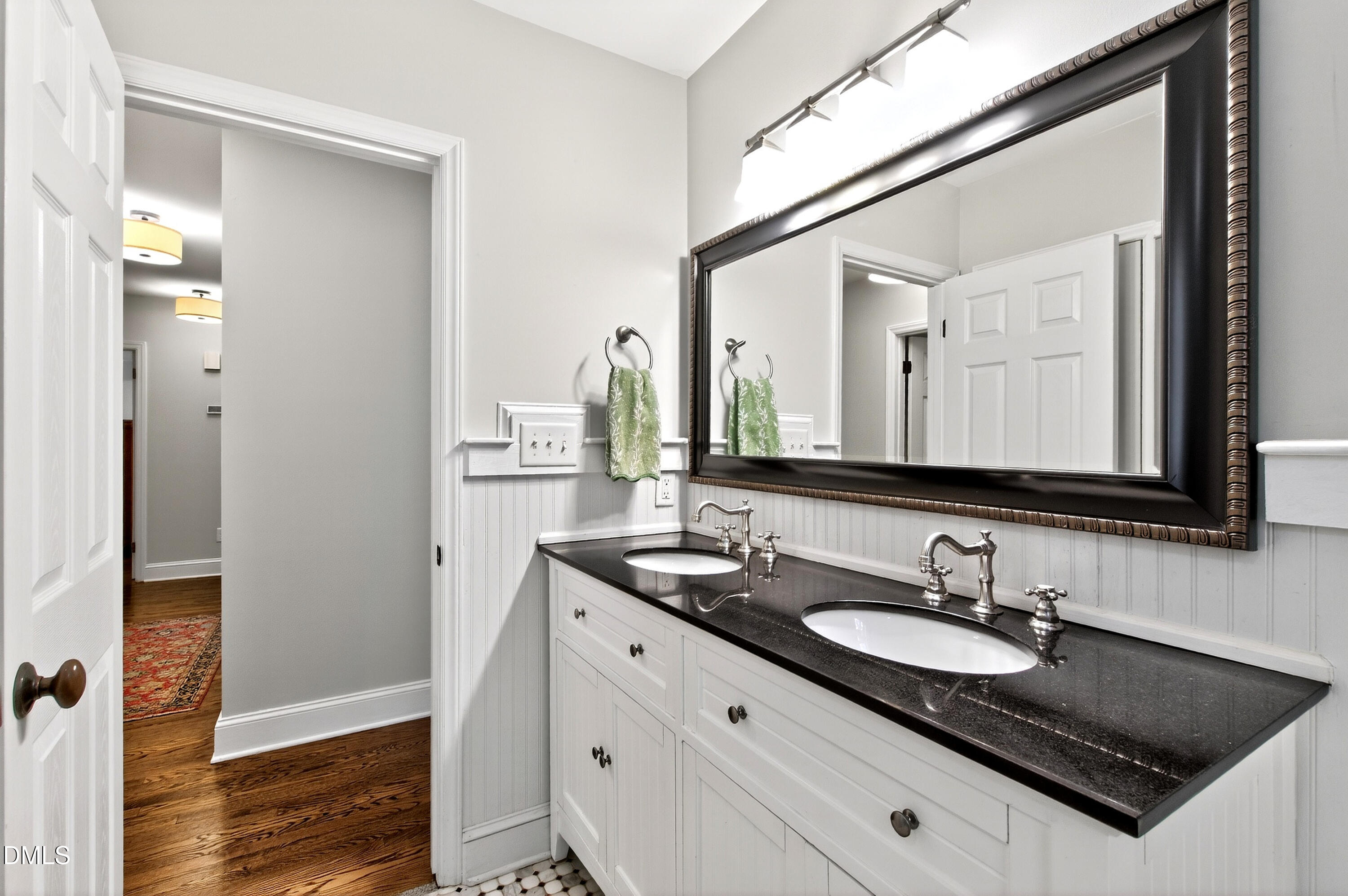 1205 Canterbury Road Raleigh, NC 27608 - Photo 30 of 48 a bathroom with a granite countertop sink and a mirror