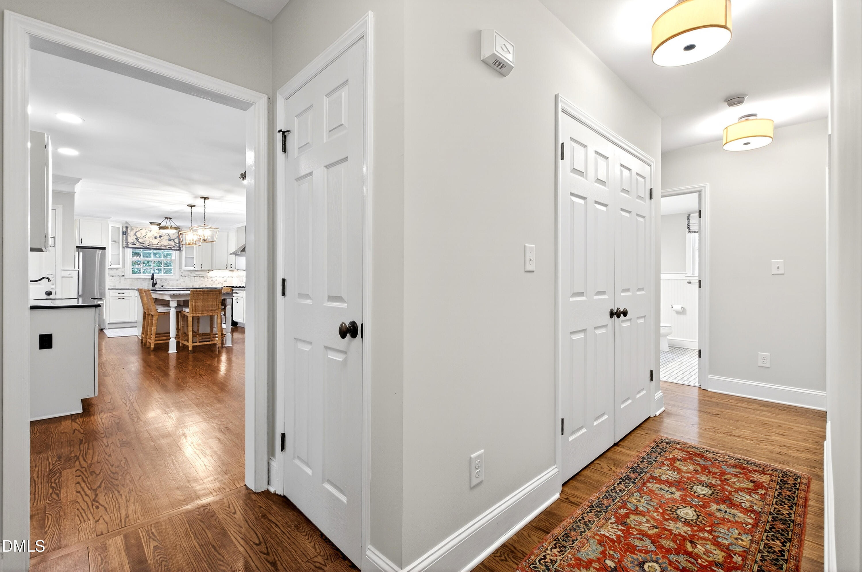 1205 Canterbury Road Raleigh, NC 27608 - Photo 32 of 48 a view of a hallway with wooden floor windows and a bathroom