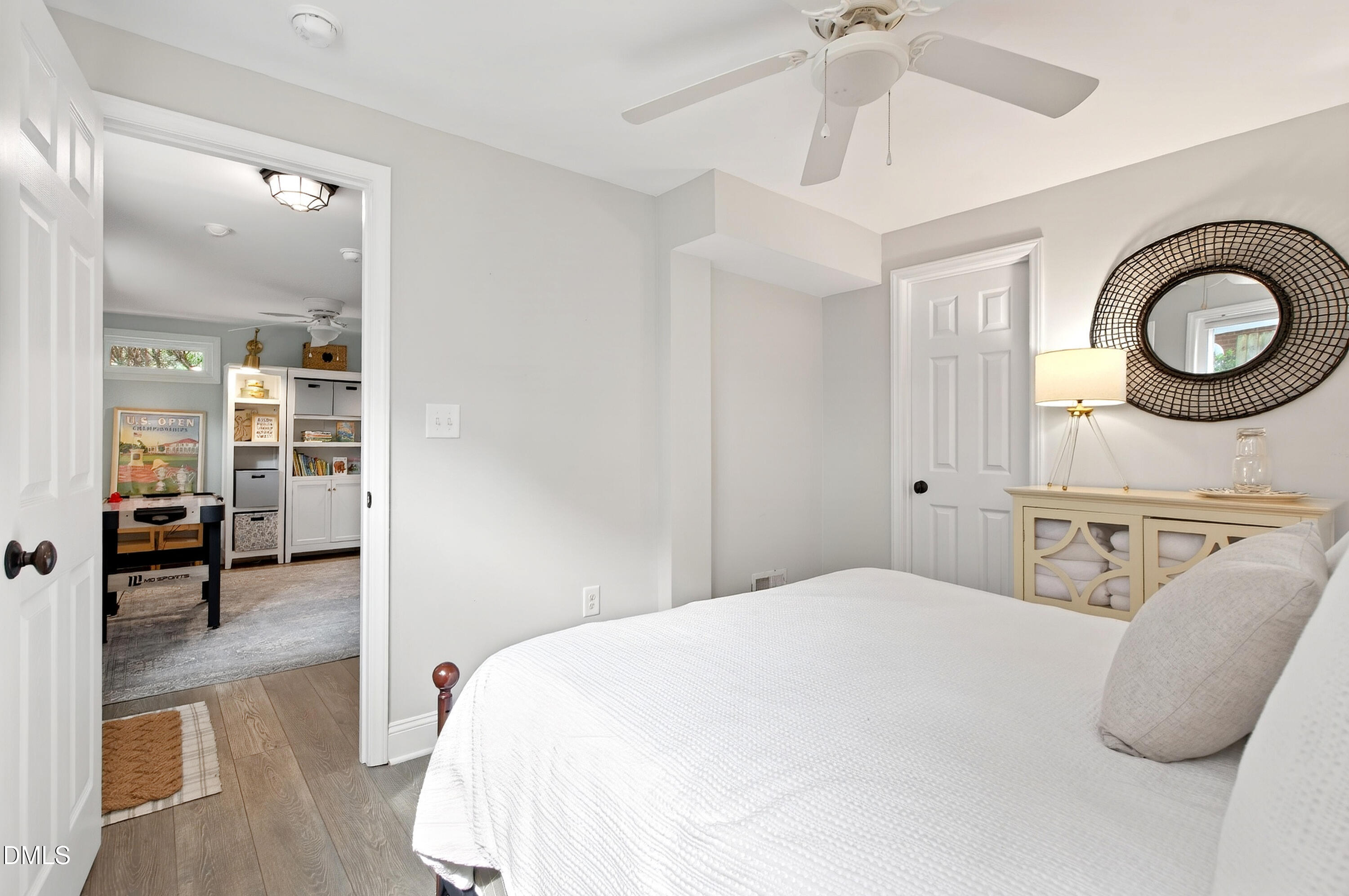 1205 Canterbury Road Raleigh, NC 27608 - Photo 37 of 48 a bedroom with a bed and a chandelier