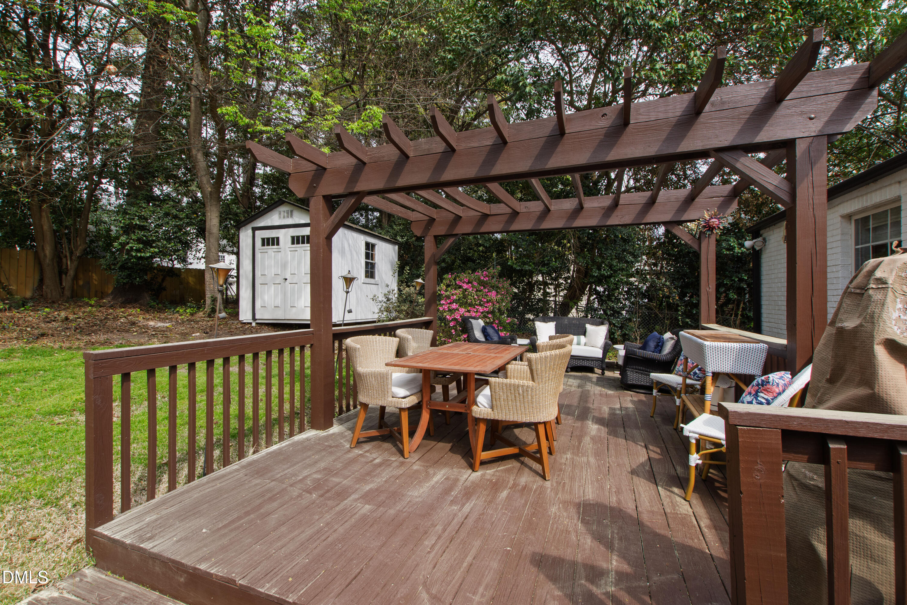 1205 Canterbury Road Raleigh, NC 27608 - Photo 39 of 48 a view of a patio with table and chairs under an umbrella with wooden floor