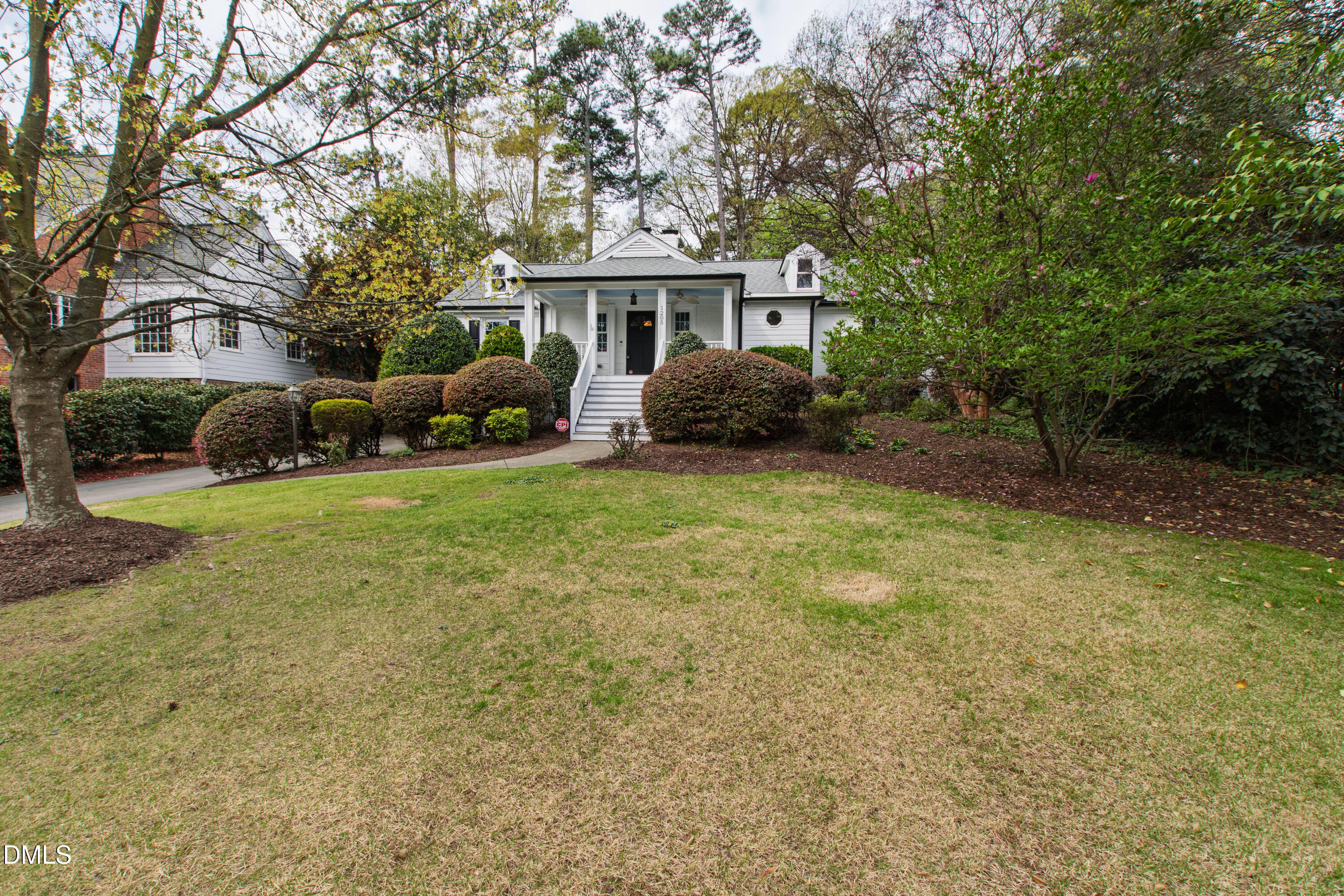 1205 Canterbury Road Raleigh, NC 27608 - Photo 3 of 48 a view of a house with a yard and sitting area