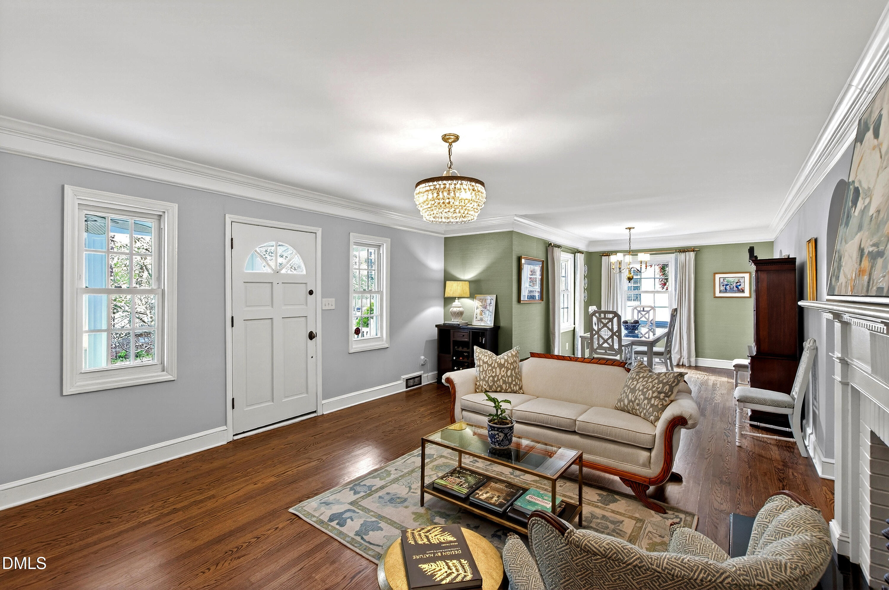 1205 Canterbury Road Raleigh, NC 27608 - Photo 5 of 48 a living room with furniture a chandelier and a window