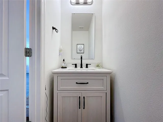 a kitchen with granite countertop a stove a sink dishwasher and a refrigerator with wooden floor