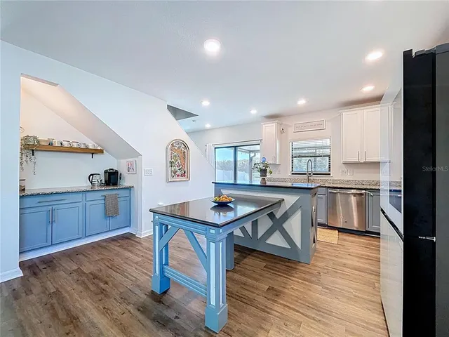 a kitchen with granite countertop a sink and a stove