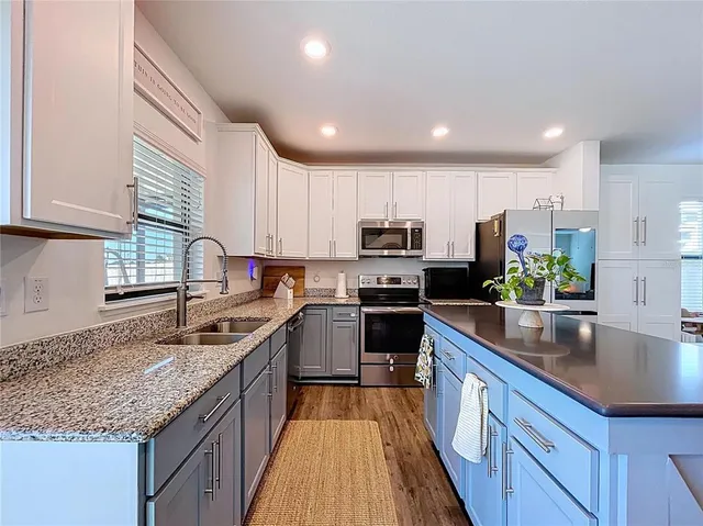 a bathroom with a granite countertop sink a toilet and a mirror