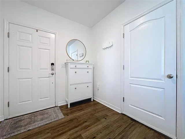 a view of a room with wooden floor