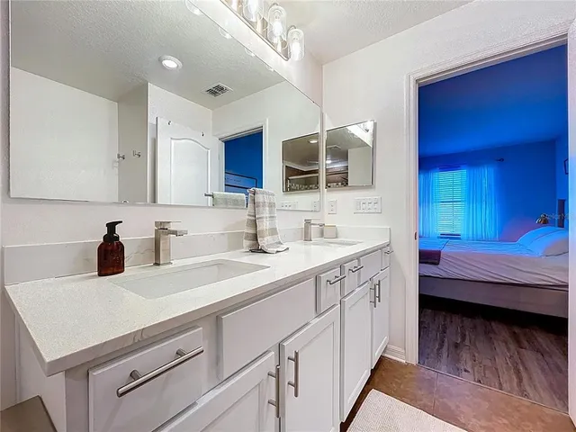 a view of swimming pool with outdoor seating and lake view