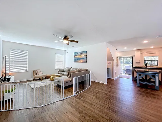 a living room with furniture and a wooden floor